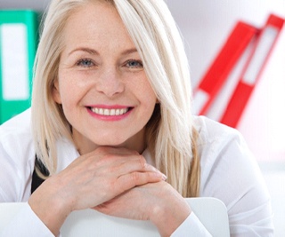 Middle-aged woman smiling with white background